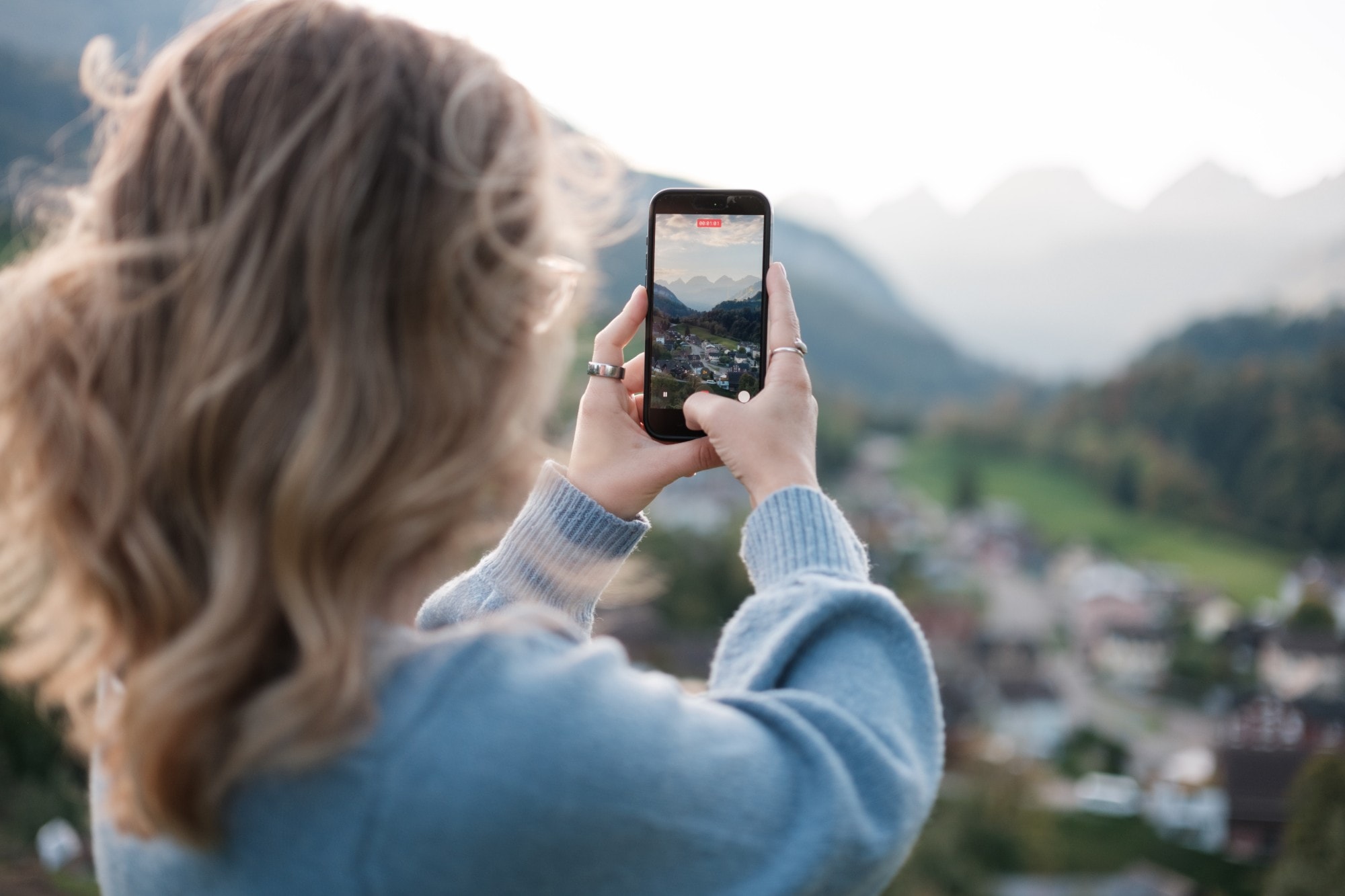 Elena Kuriger filmt mit dem Smartphone ein Bergtal
